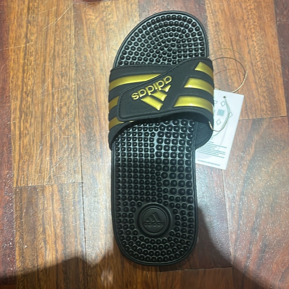 Uni sex black and gold slides, adidas size 7 men size 8 women